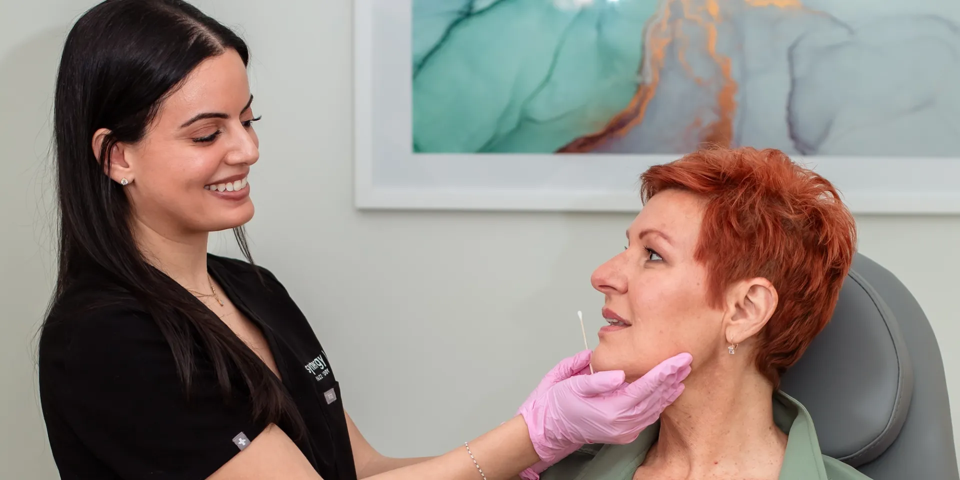 Fashionable woman wearing sunglasses and a gray scarf outside in the city